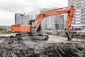 Orange excavator on a construction site