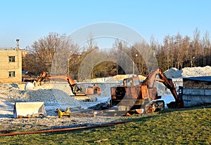 Orange excavator working on an industrial building site