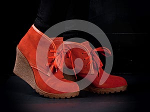 Orange fashion boots on black