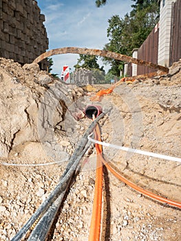 Orange fiber optic cables on a construction site