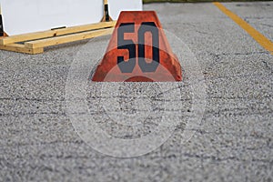 A orange fifty yard line marker ready for a marching band rehearsal