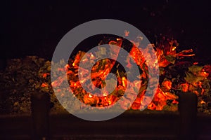 Orange flames in ash in fireplace