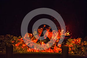 Orange flames in ash in fireplace