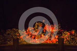 Orange flames in ash in fireplace