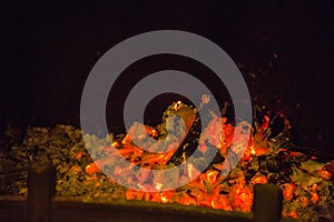 Orange flames in ash in fireplace