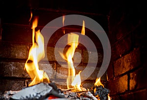 orange flames of fire in the fireplace. Horizontal