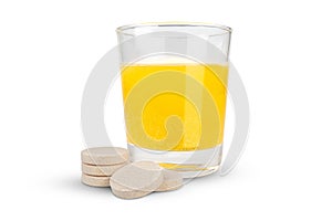 Orange flavored vitamin c effervescent tablet and dissolve in glass of water islated on white background with clipping paths