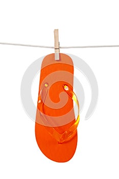 Orange flip - flop on clothesline