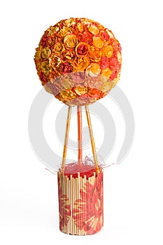 Orange floral topiary over white background