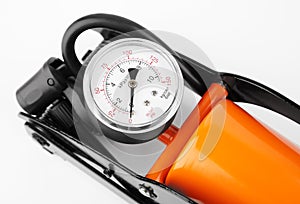 orange foot pump for a car with a manometer