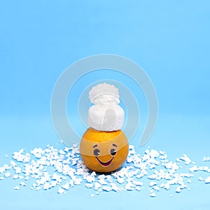 Orange in form of funny little man in winter