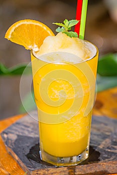 Orange frappe placed on a table ready to be served.