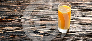 Orange fresh juice and oranges on a wooden surfacer