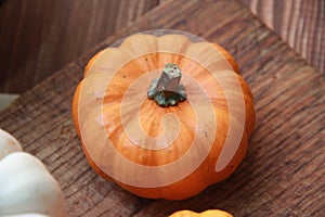 orange fresh pumpkin close-up on a wooden table