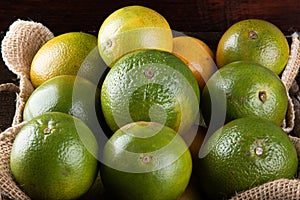 Orange fruit in the basket. Tropical fruits