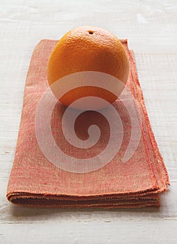 Orange fruit on a burnt orange colored napkin placemat