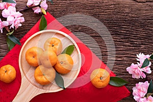 Orange fruit and cherry blossom on wood table, Chinese new year celebration background