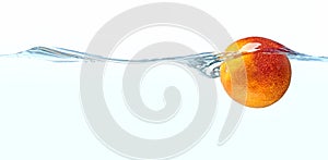 Orange fruit floating in water