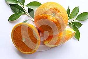 Orange fruit, fruits or vegetables half and slice with green leaves  isolated on white background closeup.