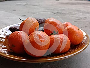 Orange fruit on glass plate outside room