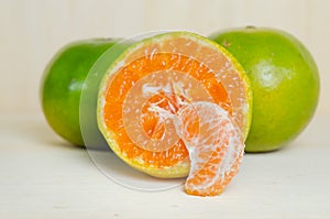 Orange fruit with half view isolated on wood background