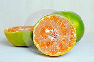 Orange fruit with half view on wood background