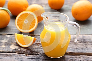 Orange fruit with jug of juice