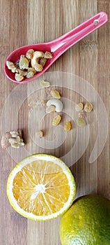 Orange fruit with nuts and raisins in wooden