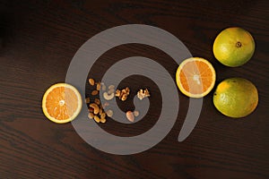 Orange fruit with nuts and raisins in wooden