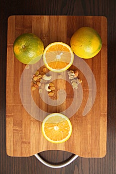 Orange fruit with nuts and raisins in wooden