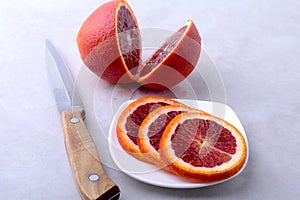 Orange fruit. Orange and lemon slice on white plate. Top view