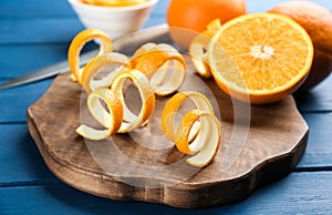 Orange fruit with peels on blue wooden table