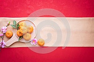 Orange fruit, Pink cherry blossom with Copy space for text on red texture background, Chinese new year background