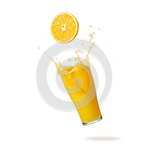Orange fruit slice and juice glass with splash and drops flying falling isolated on white background