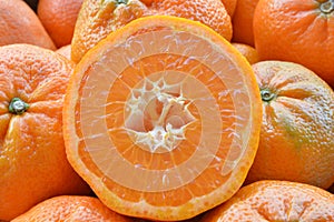 An orange fruit sliced in two