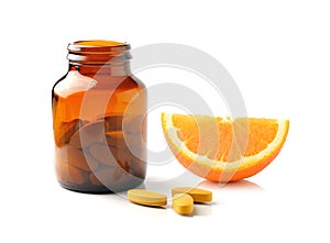 Orange fruit with vitamin c tablet on white background