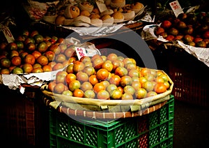 Orange fruits in basket for sale in urban market