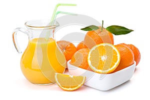 Orange fruits and jug of juice