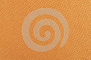 Orange geometric texture embossed on hard cardboard