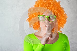 Orange Girl with Finger on Lips