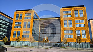 Orange and glass facade of building. Modern architecture. Skyscraper geometry. Business office park. Urban real estate. Economics