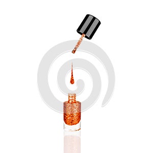 Orange glittering nail polish glass bottle, brush, flowing drop white background isolated close up, opened red sequin varnish