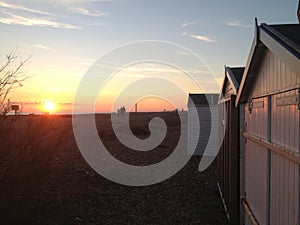 Sunset over Shoreham beach huts in East Sussex