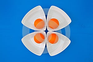 Orange golf balls on the triangular ceramic bowls