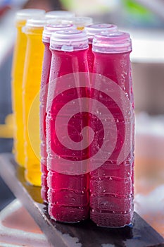 Orange and granade juice in plastic bottles photo