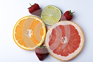 Orange grapefruit Strawberry and lime citruses on a white background isolate