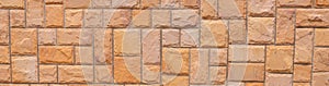 Orange grunge stone wall texture background for exterior decoration.