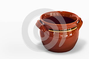 Orange handmade fictile pot in a white background photo