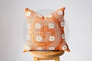 Orange handmade knitted pillow.