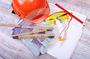 Orange hard hat, earplug, safety glasses and gloves for work. Earplug to reduce noise on a white background.